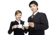 © Blue Jean Images - Young businessman and businesswoman having coffee together