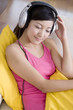 © Blue Jean Images - Asian woman listening to music