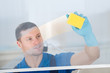 © Andrey Popov - Worker Cleaning Glass With Rag