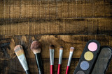 Fototapeta Sypialnia - Make-up brushes and mascara set on wooden table