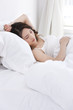 © Blue Jean Images - Young woman sleeping in bed