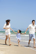 © Blue Jean Images - Family running on the beach