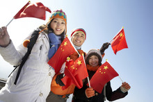 Young People Waving Flags On The Great Wall Of China
