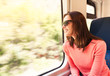 © kieferpix - Young woman enjoying a train ride.