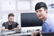 © Blue Jean Images - Young man with colleague in office