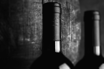 Wall Mural - red wine bottle - tilt shift selective focus effect black and white photo
