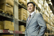 © Blue Jean Images - Confident businessman in warehouse