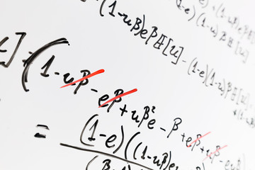 Complex math formulas on whiteboard. Mathematics and science with economics