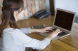 © Blue Jean Images - Young woman using laptop in office