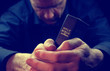 © Duncan Andison - A Man praying holding a Holy Bible.