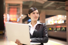 Young Businesswoman Using Her Laptop At The Train Station
