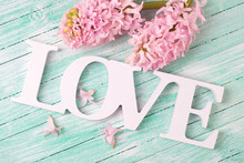 Word Love And Pink Hyacinths Flowers  On Turquoise Wooden Backgr