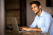 © luckybusiness - Handsome man using laptop