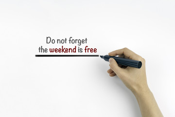 Hand with marker writing the text: Do not forget the weekend is