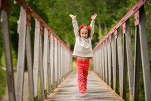 Cute Little Girl Having Fun In A Rural Bridge
