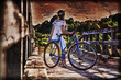 © Sergey Khamidulin - Beautiful girl with a bicycle on the bridge.