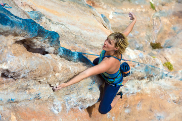 Wall Mural - Top View of Rock Climber on orange Vertical Wall