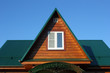 Green metal roof  and attic window closeup