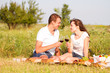 © yatcenko - Young beautiful couple in love relaxing on a picnic outdoor