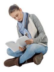  beautiful girl sitting cross-legged, reading a book on a white