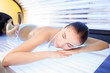 Attractive woman is getting sunbathing beauty treatment