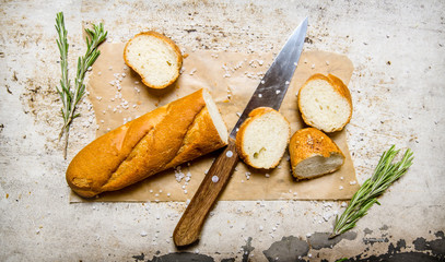 Poster - Ciabatta with herbs on paper. On rustic background.