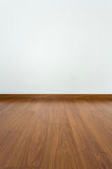 Poster - empty room with brown wood laminate floor and white mortar wall