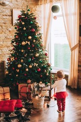 Happy little smiling girl with christmas gift box