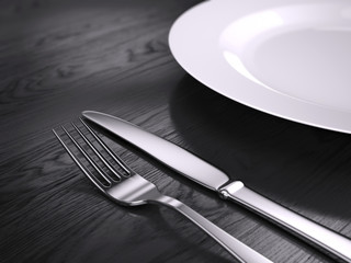 Empty plate, Fork and knife isolated on wooden table