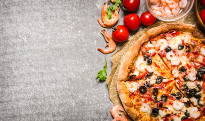 Poster - Seafood pizza with shrimp and tomatoes. On stone table.