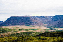Large Mountain Plateau And Valley Under Cloudy Sky