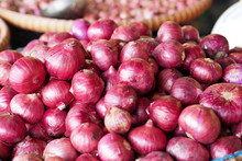 Big Red Onions In The Flat Basket Stall At Market For Sell