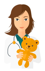 Wall Mural - Pediatrician holding teddy bear.