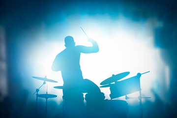 Wall Mural - Drummer playing on drums on music concert. Club lights