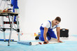 © Africa Studio - Worker renewing apartment on wall background