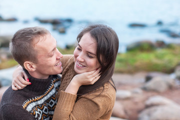 Wall Mural - Loving couple hugging on the rocky beach