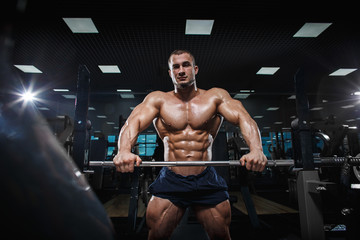 Wall Mural - Muscular athletic bodybuilder fitness model posing after exercises 
