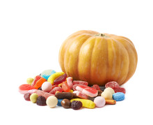 Pumpkin And Pile Of Candies Isolated