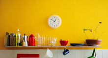 Yellow Wall Clock In The Kitchen