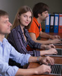 © alexbrylovhk - People working at office computers sitting in row beautiful female