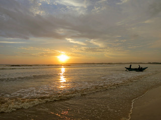 Wall Mural - Sunset beach with fisherman boat silhouette in water, Sri Lanka