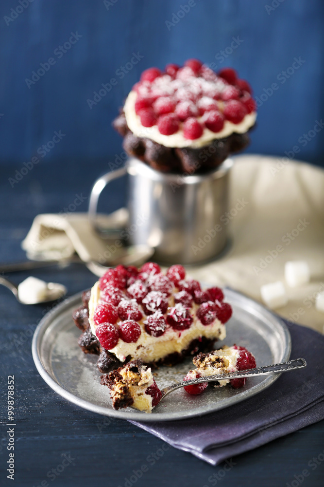 Sweet cakes with raspberries on color wooden background