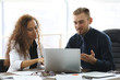 © Africa Studio - Businessman and businesswoman working in office
