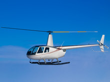 Helicopter Flying In Blue Sky Side View