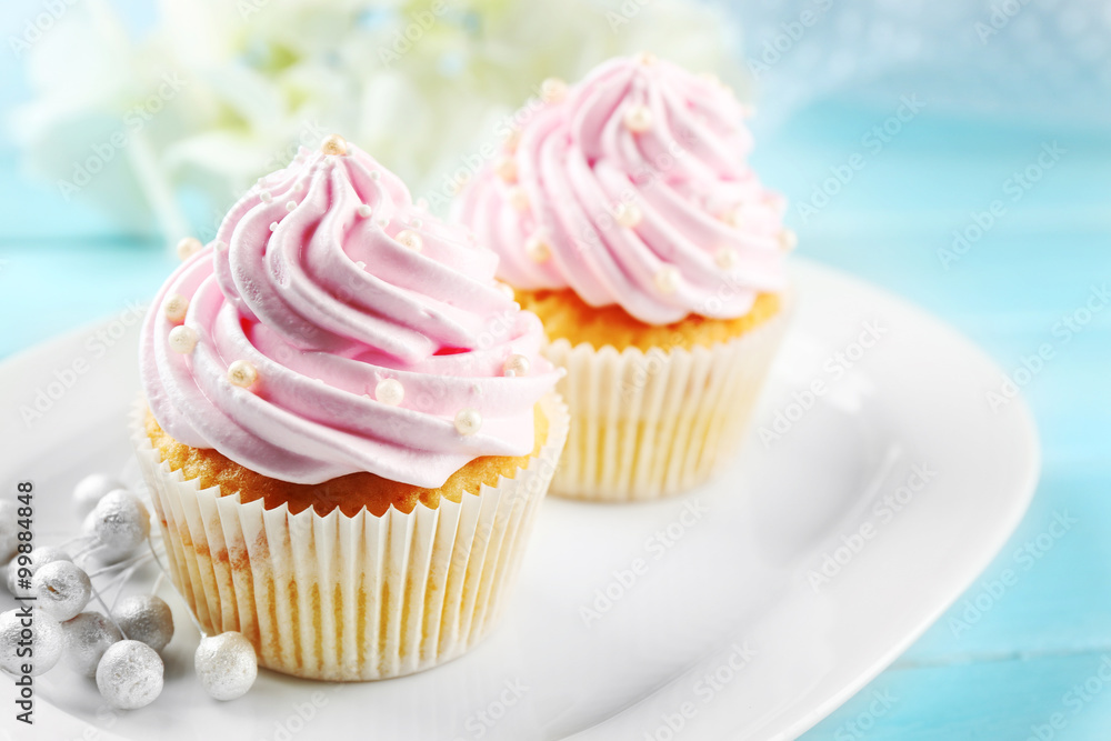 Pink cupcakes on wooden background