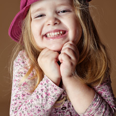 Happy smiling  little girl in a cap 