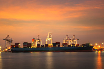 Wall Mural - container ship in import,export port against beautiful morning light of loading ship yard use for freight and cargo shipping vessel transport