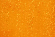 Close Up Water Drop On Dark Orange Background.