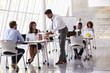 © Monkey Business - Manager Helping Staff In Busy Office Environment