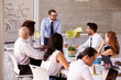 © Monkey Business - Caucasian Businessman Leading Meeting At Boardroom Table